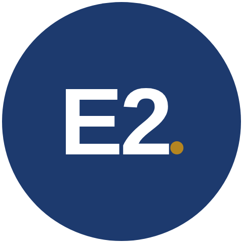 The E2 badge: E2 in white with a gold period, in a navy circle
